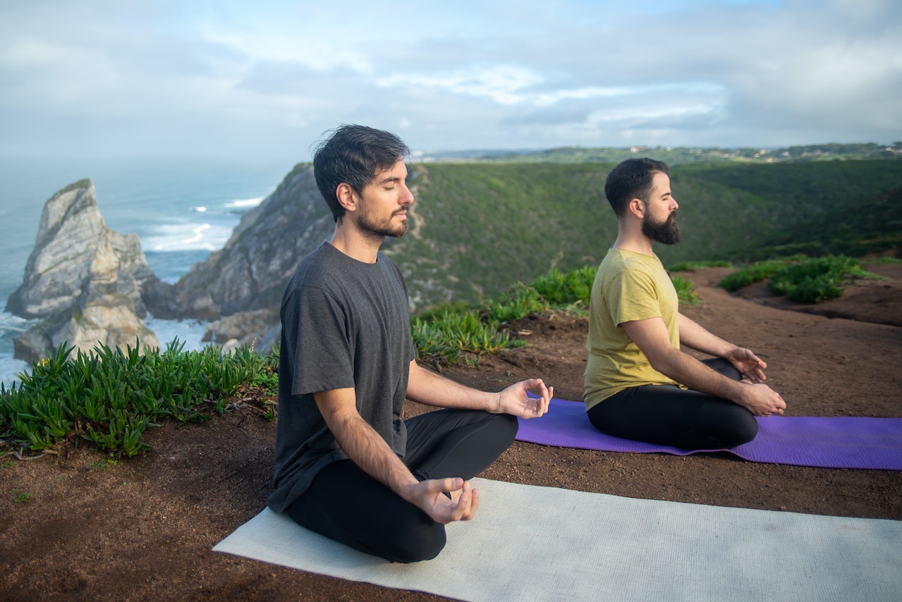 Two Men Doing Yoga In The Mountains