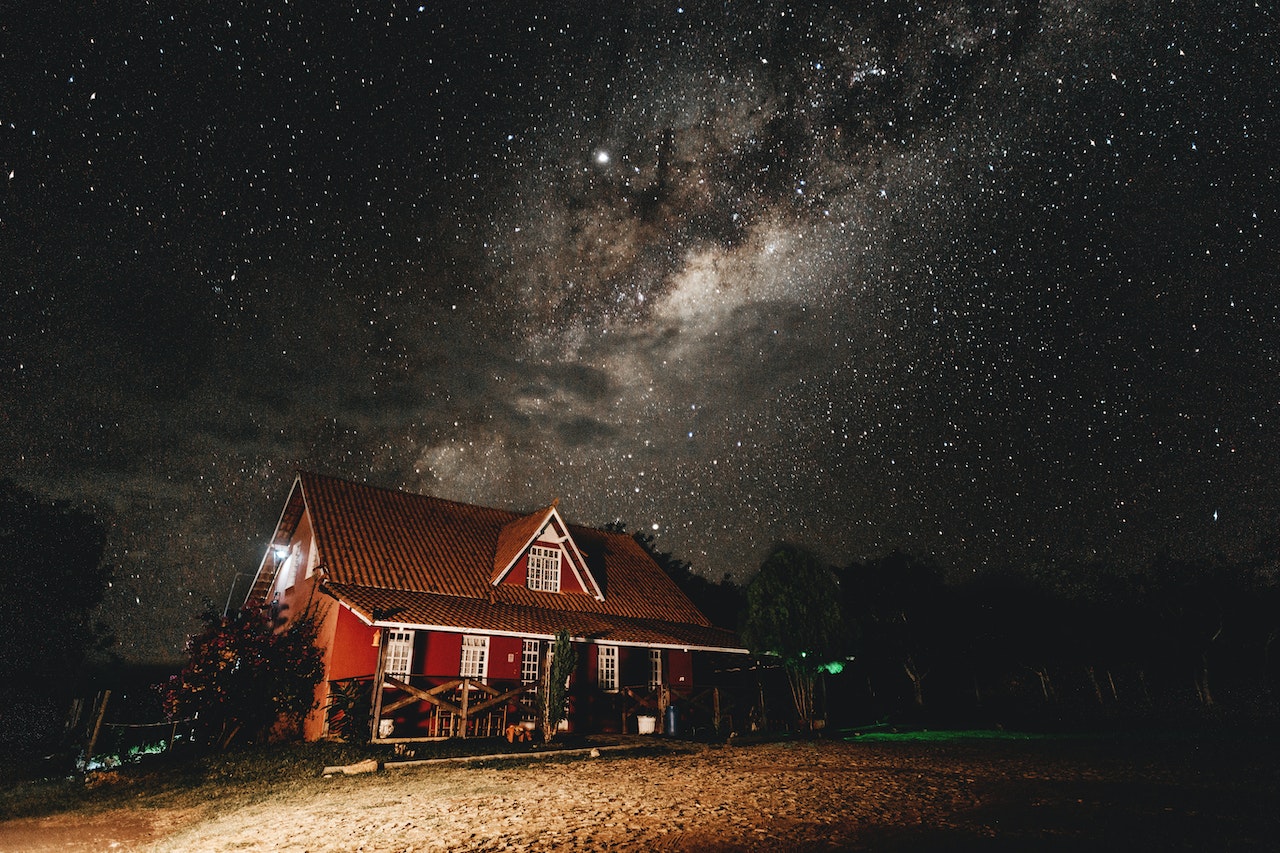 Brown Cabin Photo during Starry Nighttime