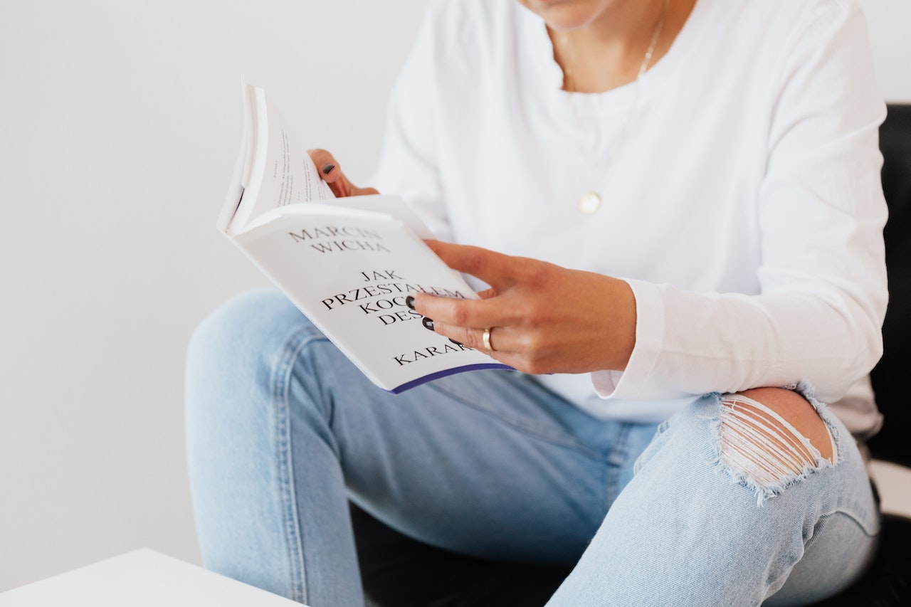Woman in casual clothes reading book