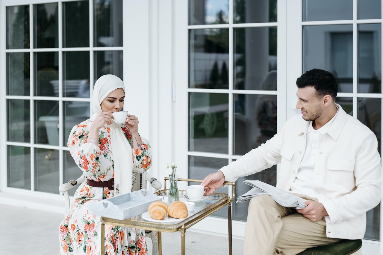 A Man and Woman Having Conversation while Drinking Coffee