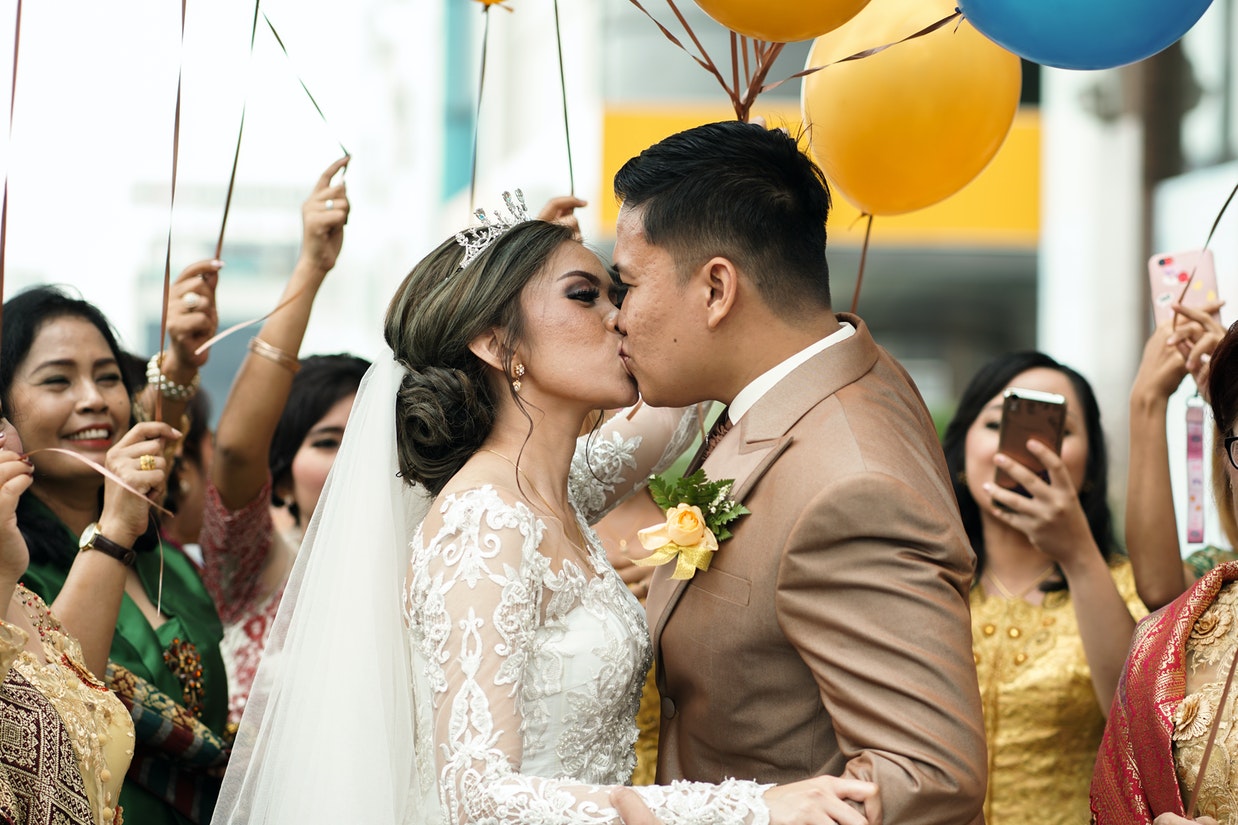 Bride And Groom Kissing in Front of Many People