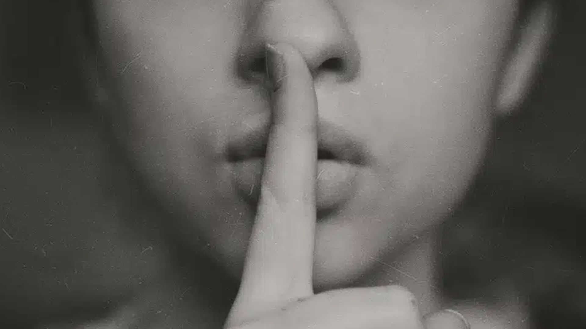 Person With A Finger On Mouth