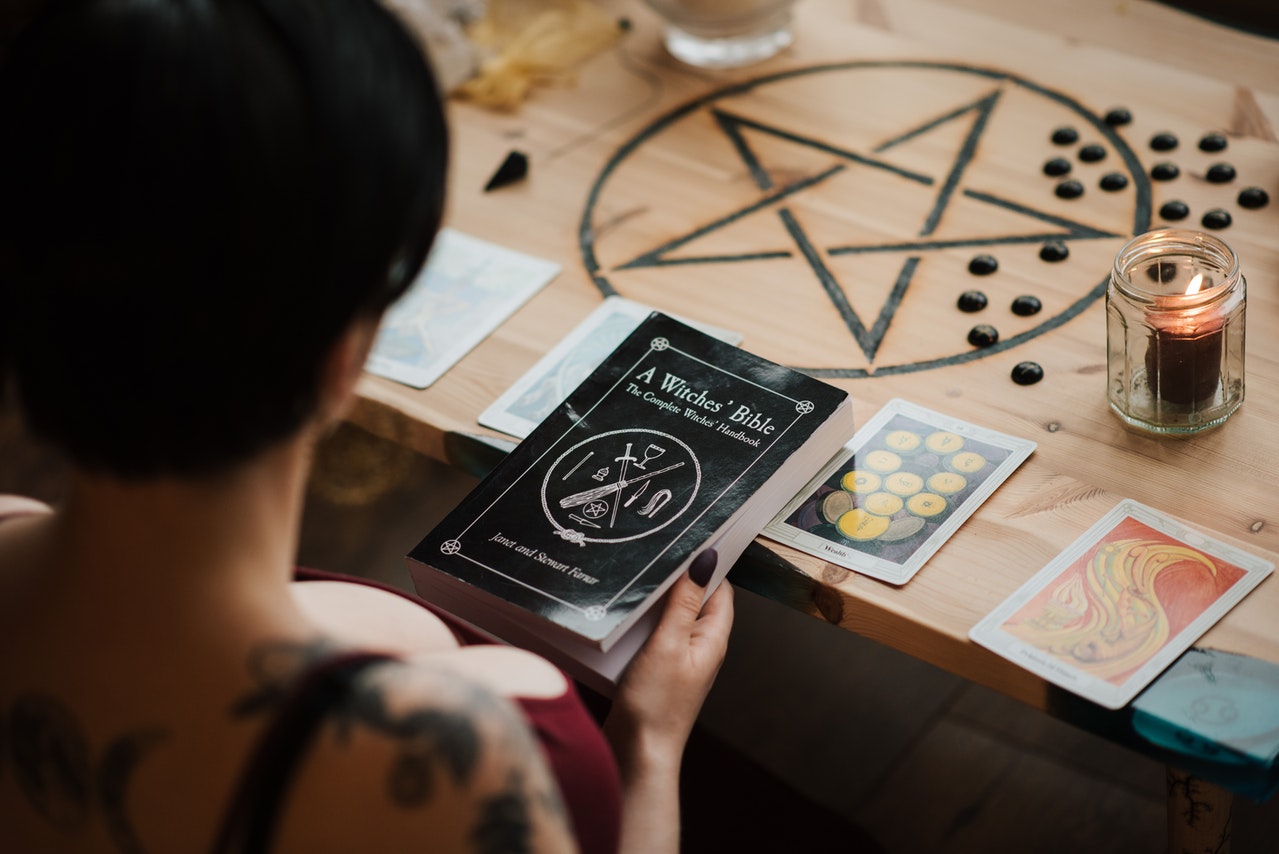 Fortune teller with textbook during divination process