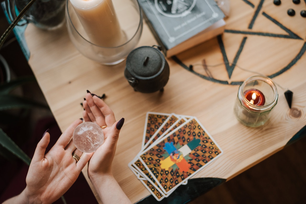 Soothsayer predicting fate with magic ball at home