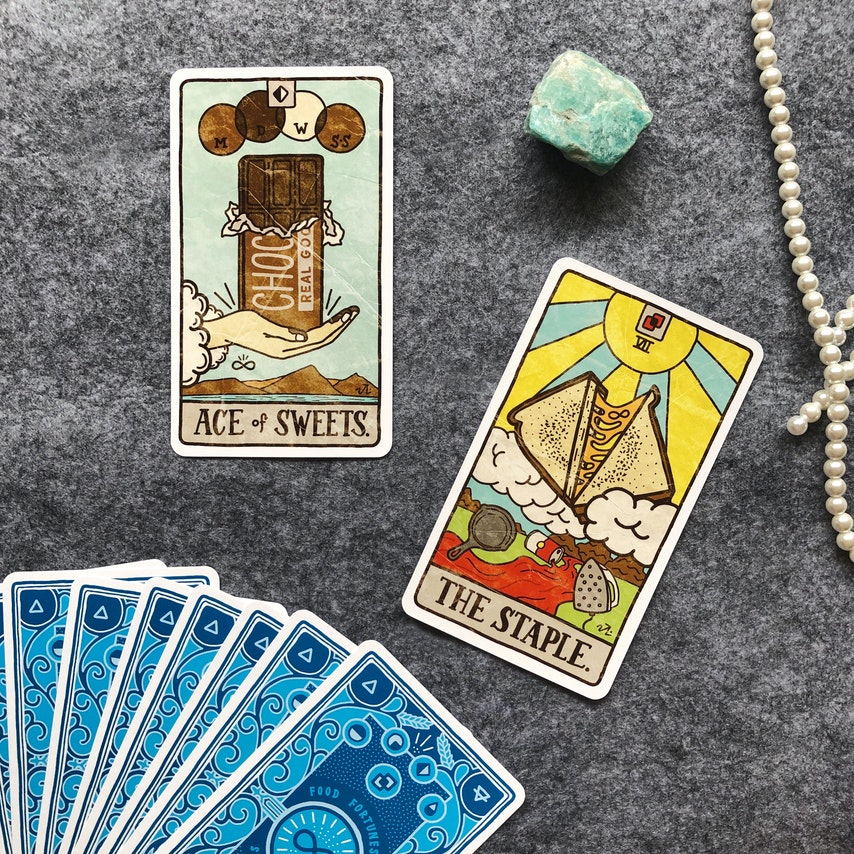 Tarot Cards, pearls, and stone on the floor