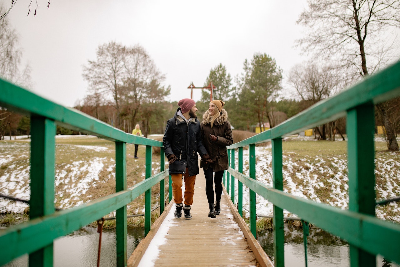 A Couple Walking on a Bridge