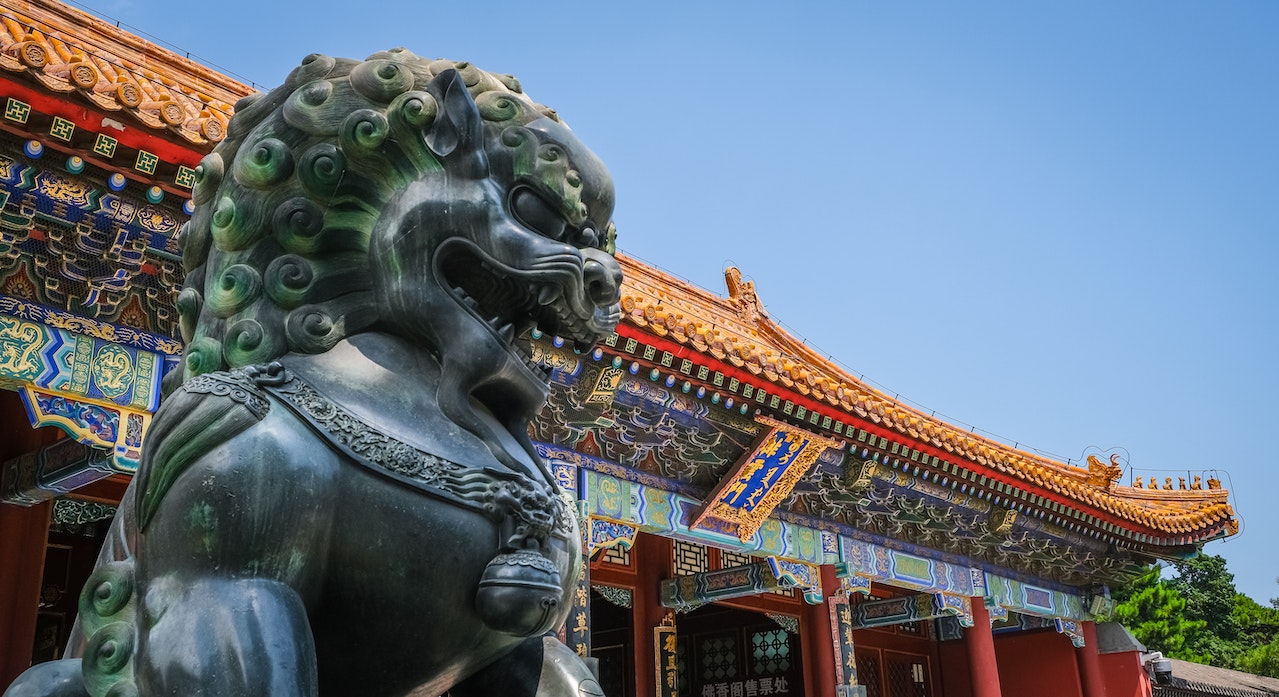 A large bronze lion statue outside a temple in the Forbidden City in Beijing, China