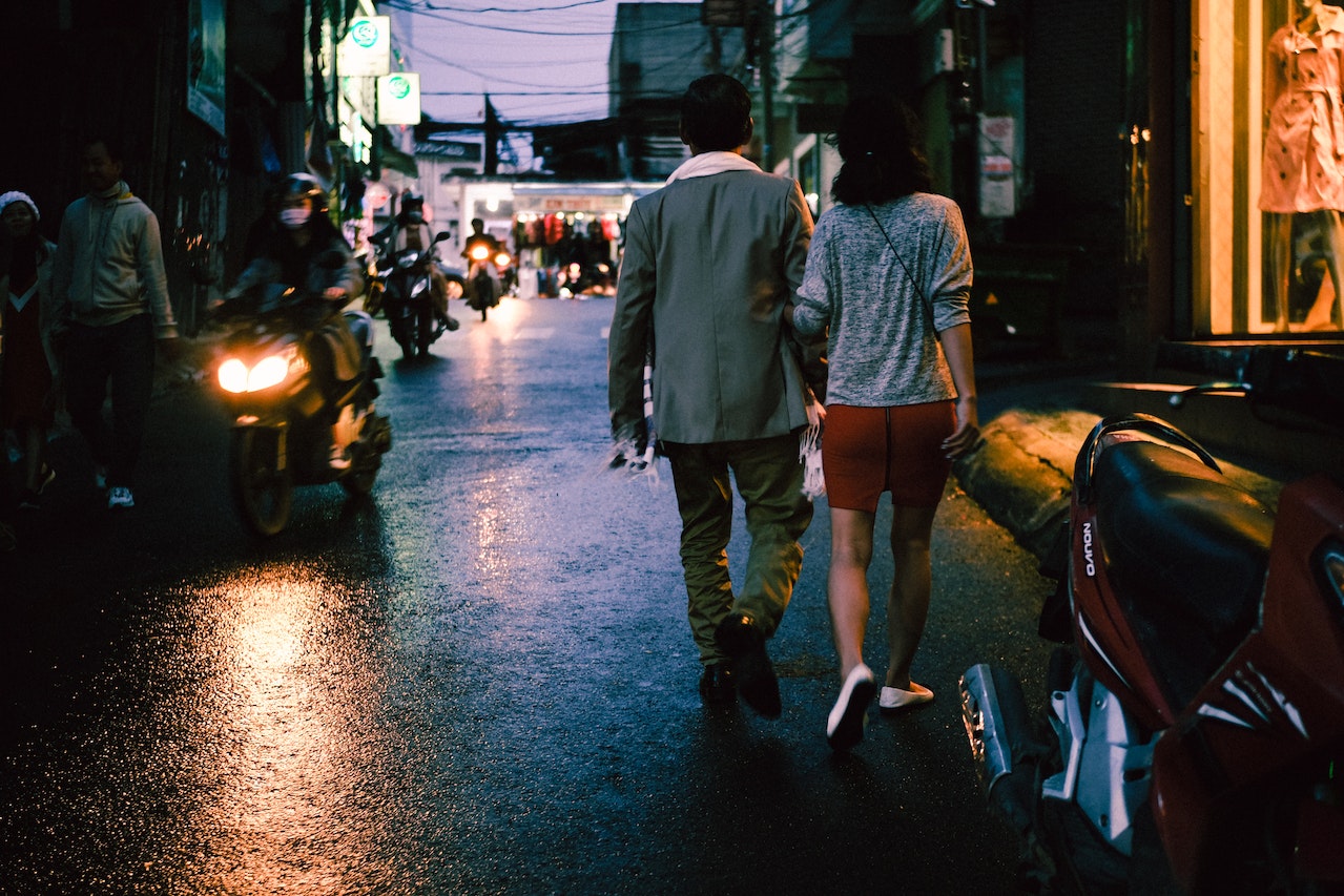 Man and Woman Walking on the Street
