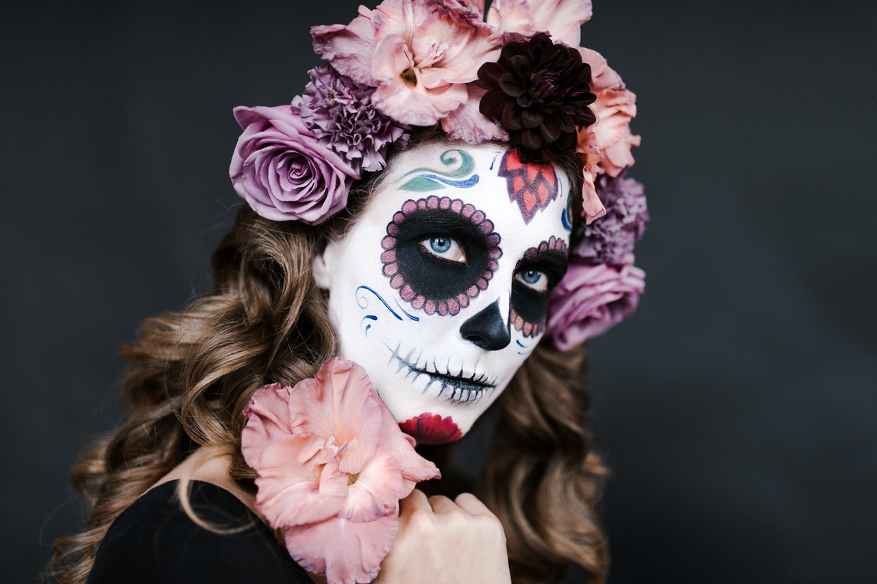 Woman with a face paint of a flowery skull