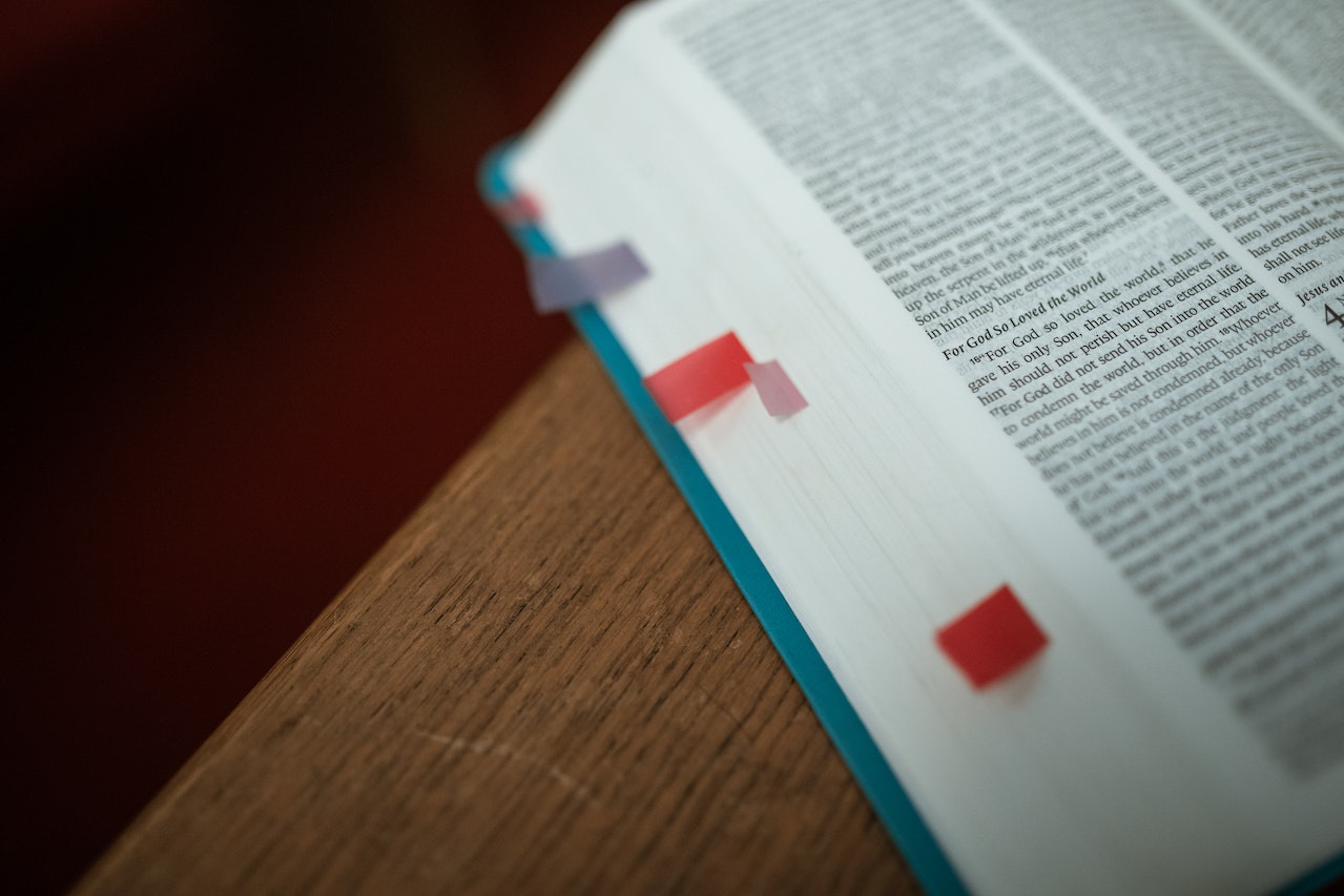 An Open Bible With Book Flags On Some Pages
