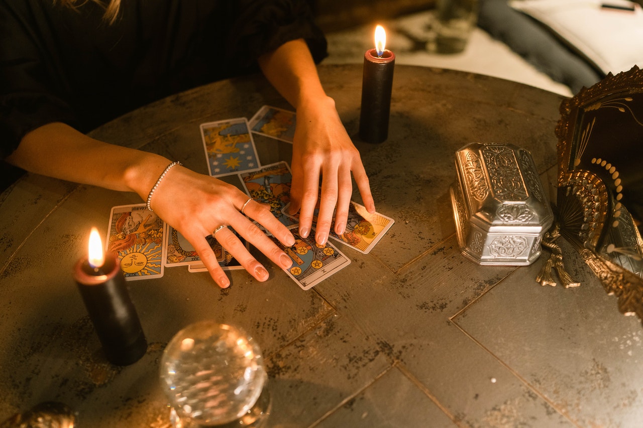 A Wman Reading the Tarot Cards on the Table