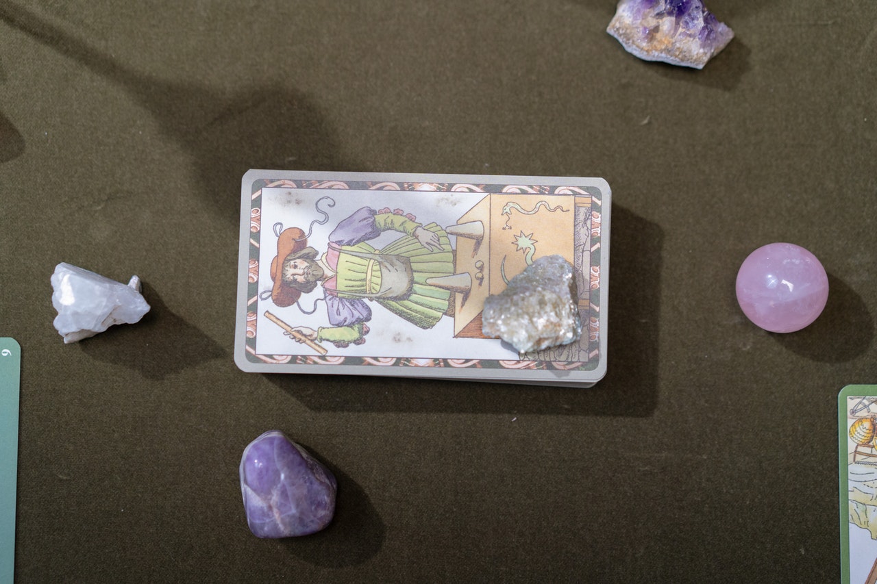 Close-Up Shot of Tarot Cards and stones on the Table