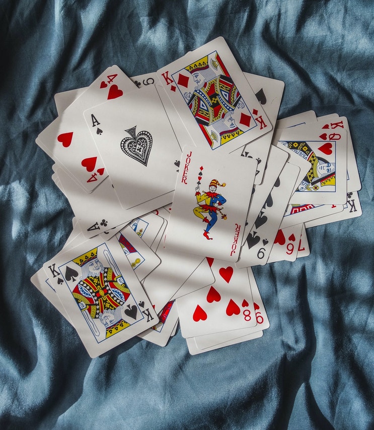 Playing Cards on a Blue Fabric