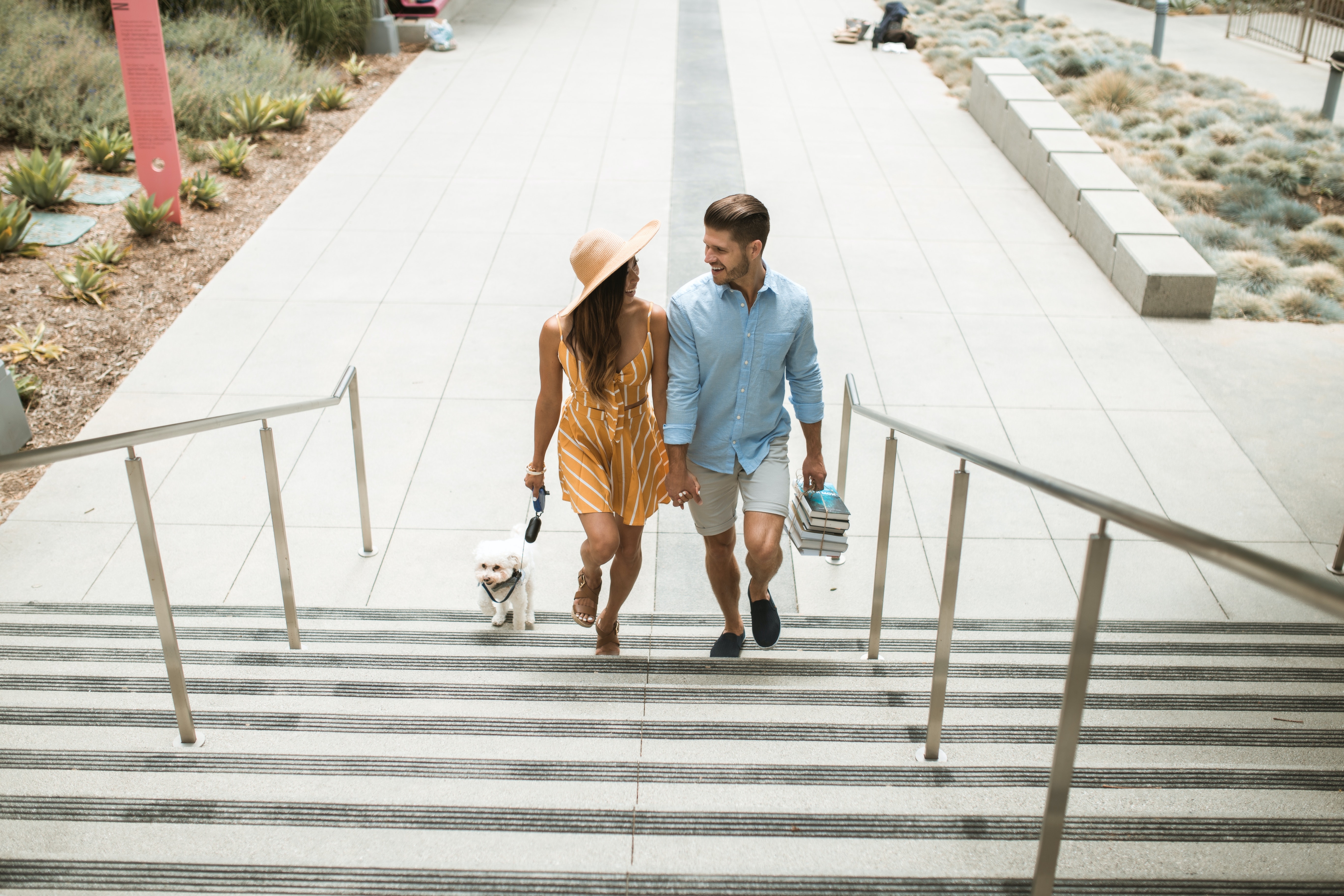 Couple Walking Up Stairs With Their Dog