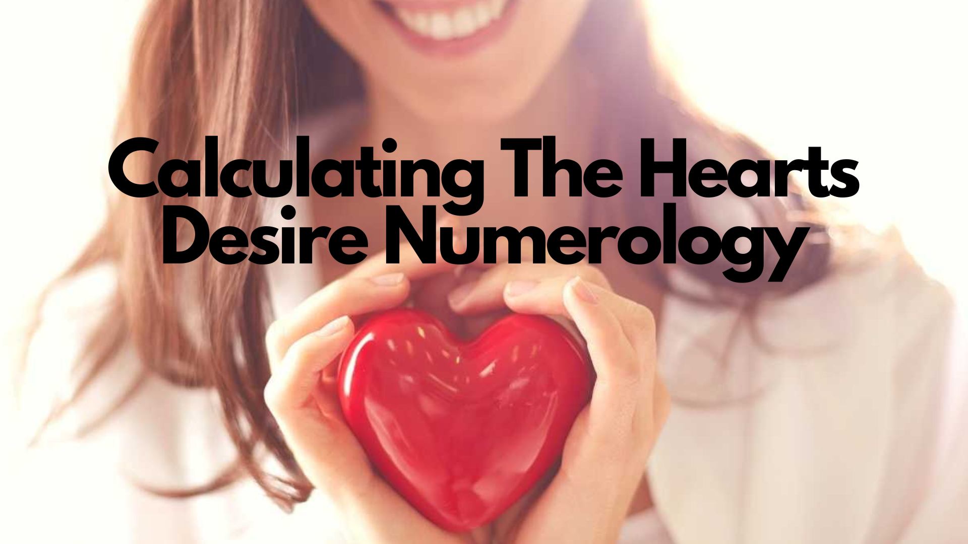 A person holding a heart shaped thing while smiling with words Calculating The Hearts Desire Numerology