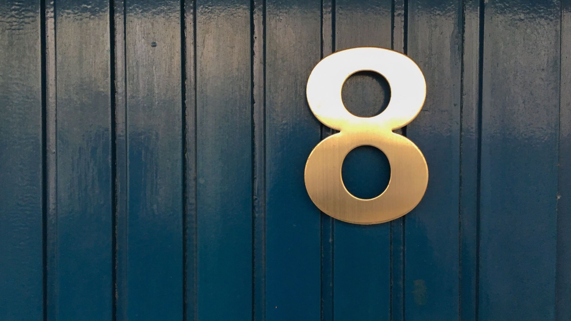 Golden Colored Number 8 On Wall