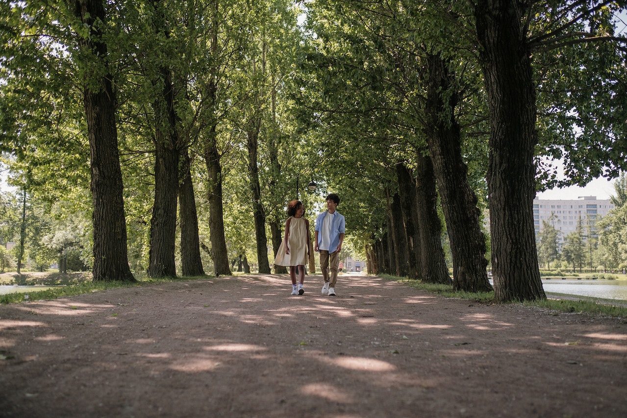 Two teenagers walking together in the park