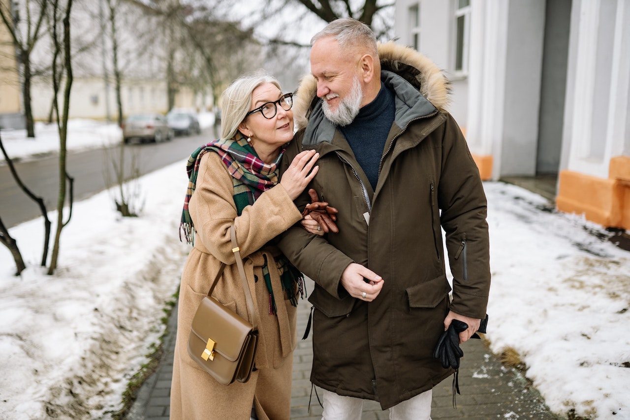 An Elderly Couple Walking on the Sidewalk