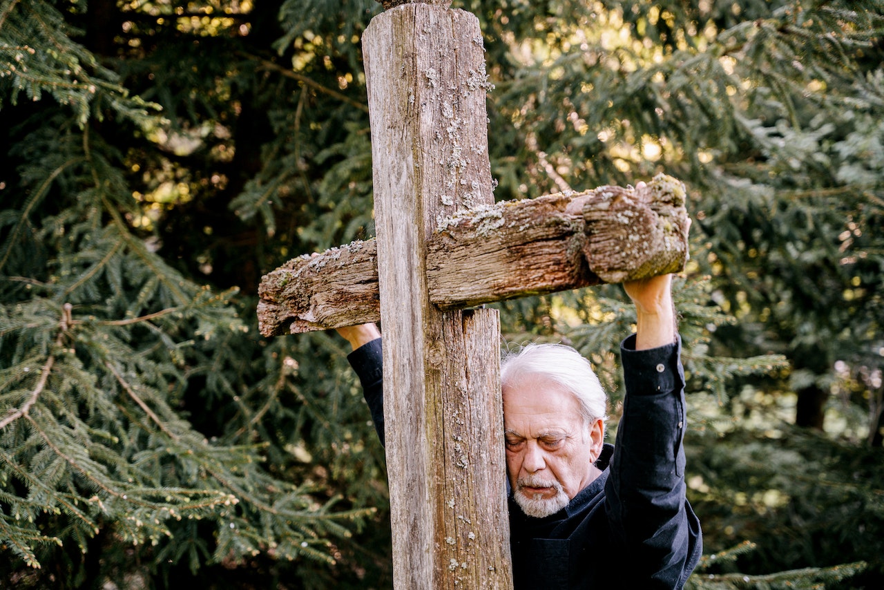 A Man Holding a Wooden Cross