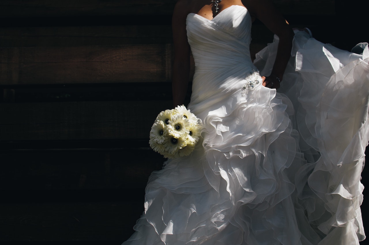 Woman in White Wedding Gown Holding Bouquet