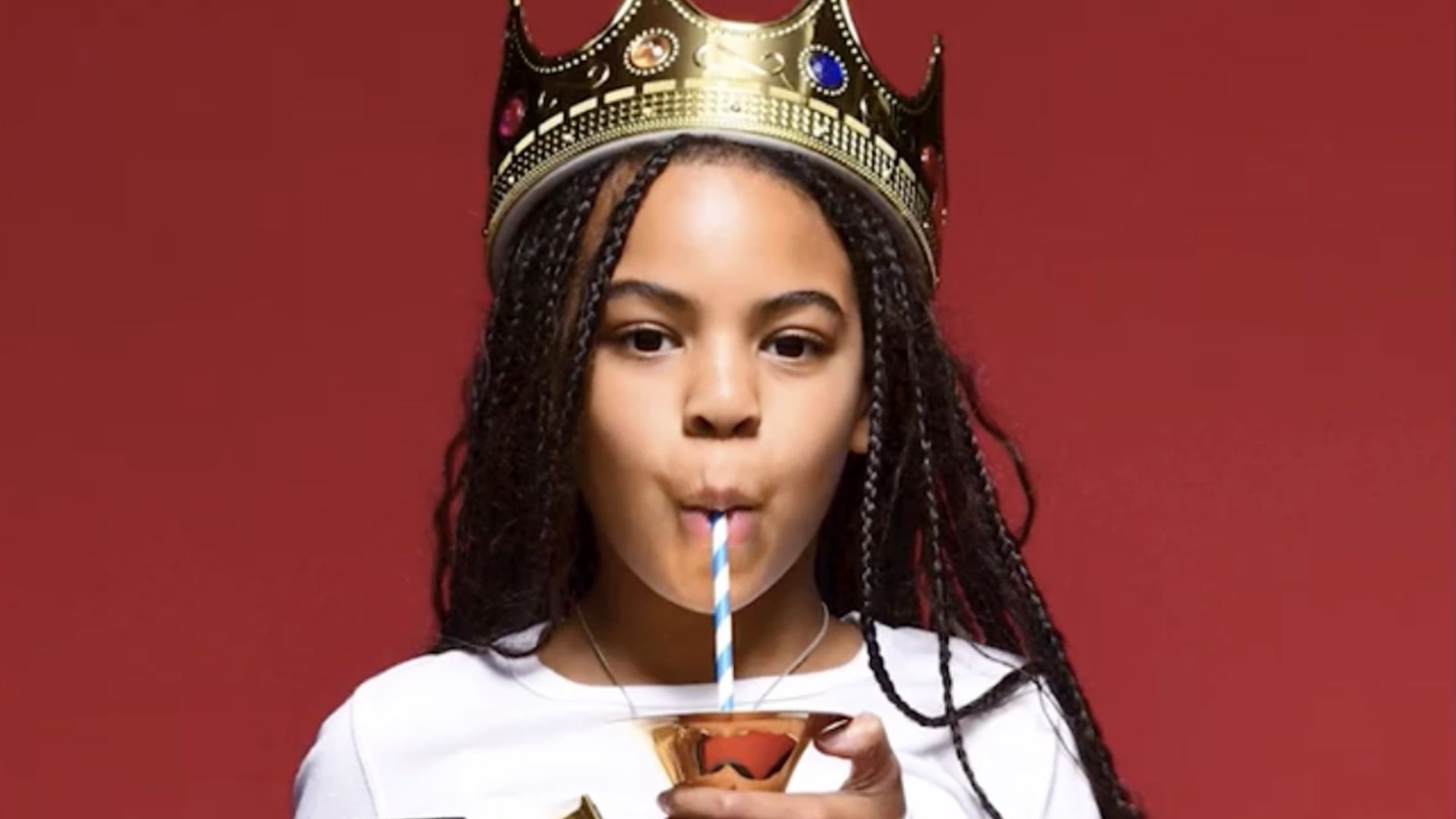 Blue Ivy Carter With A Crown On Her Head Sipping From A Straw