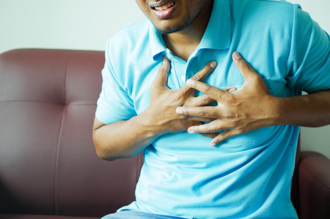  Man in Blue Polo Shirt with Hands on Chest