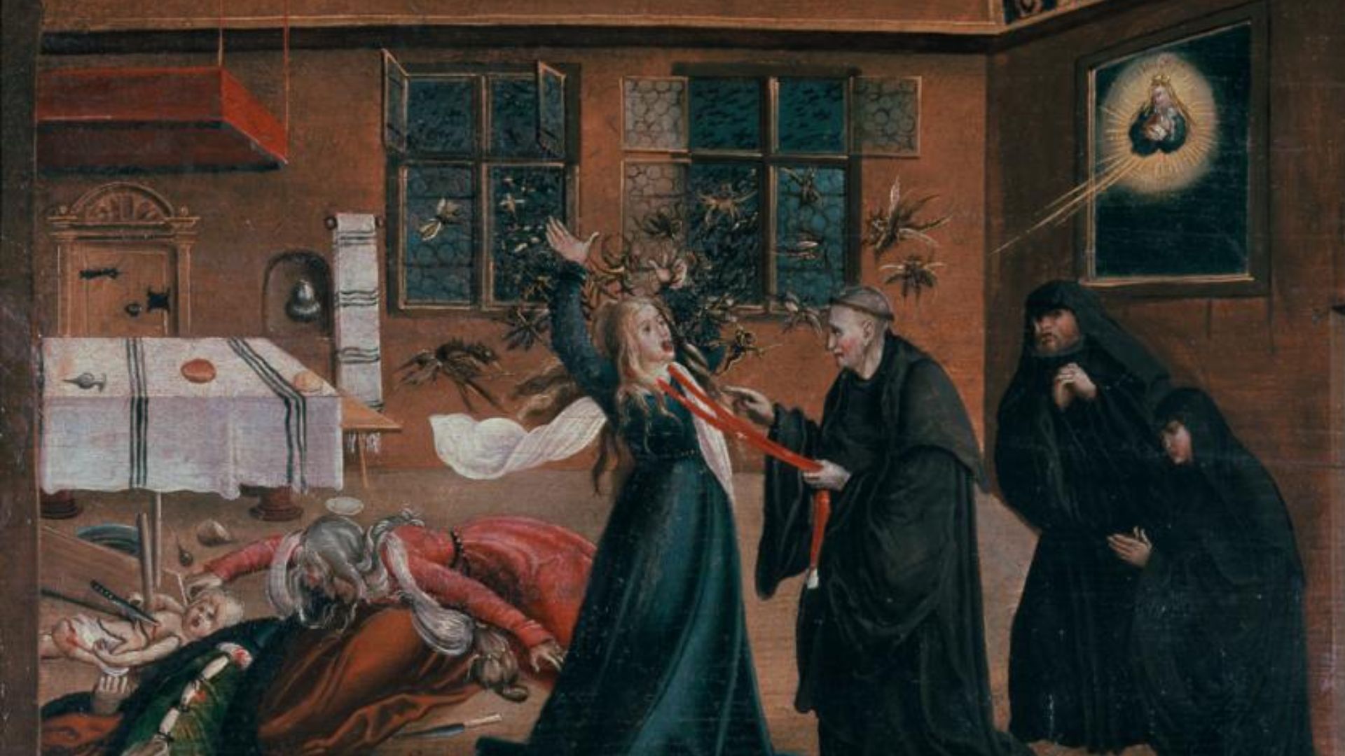 A woman grabbed by the neck with a red slim cloth held by a priest.