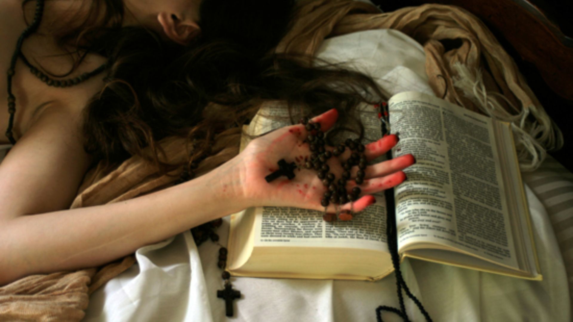 Girl With A Cross In Hand On Top Of A Bible