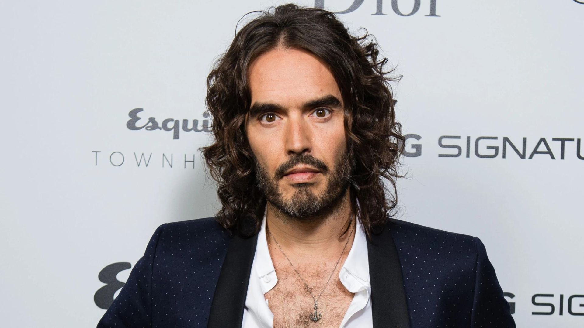 Russell Brand Wearing Black And White Suit