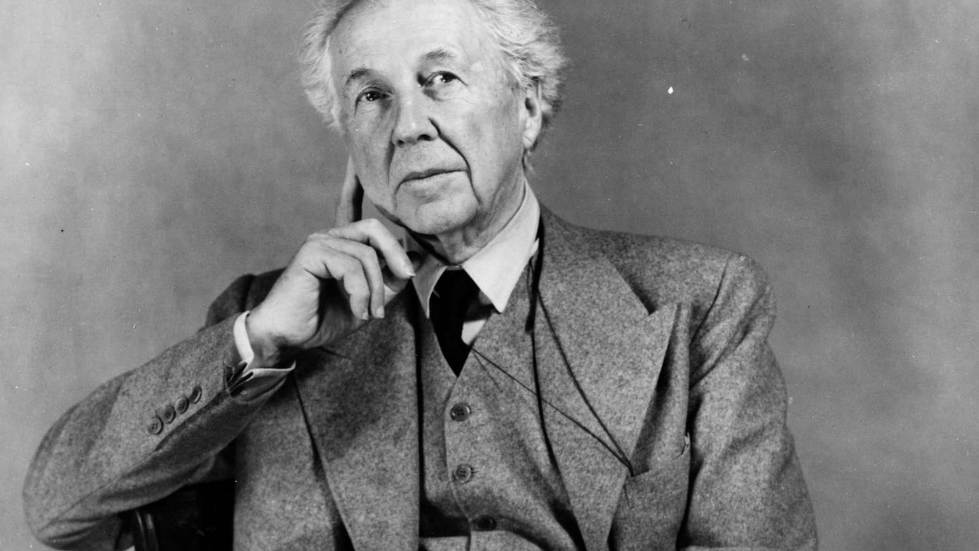 Frank Lloyd Wright Sitting And Wearing A Suit