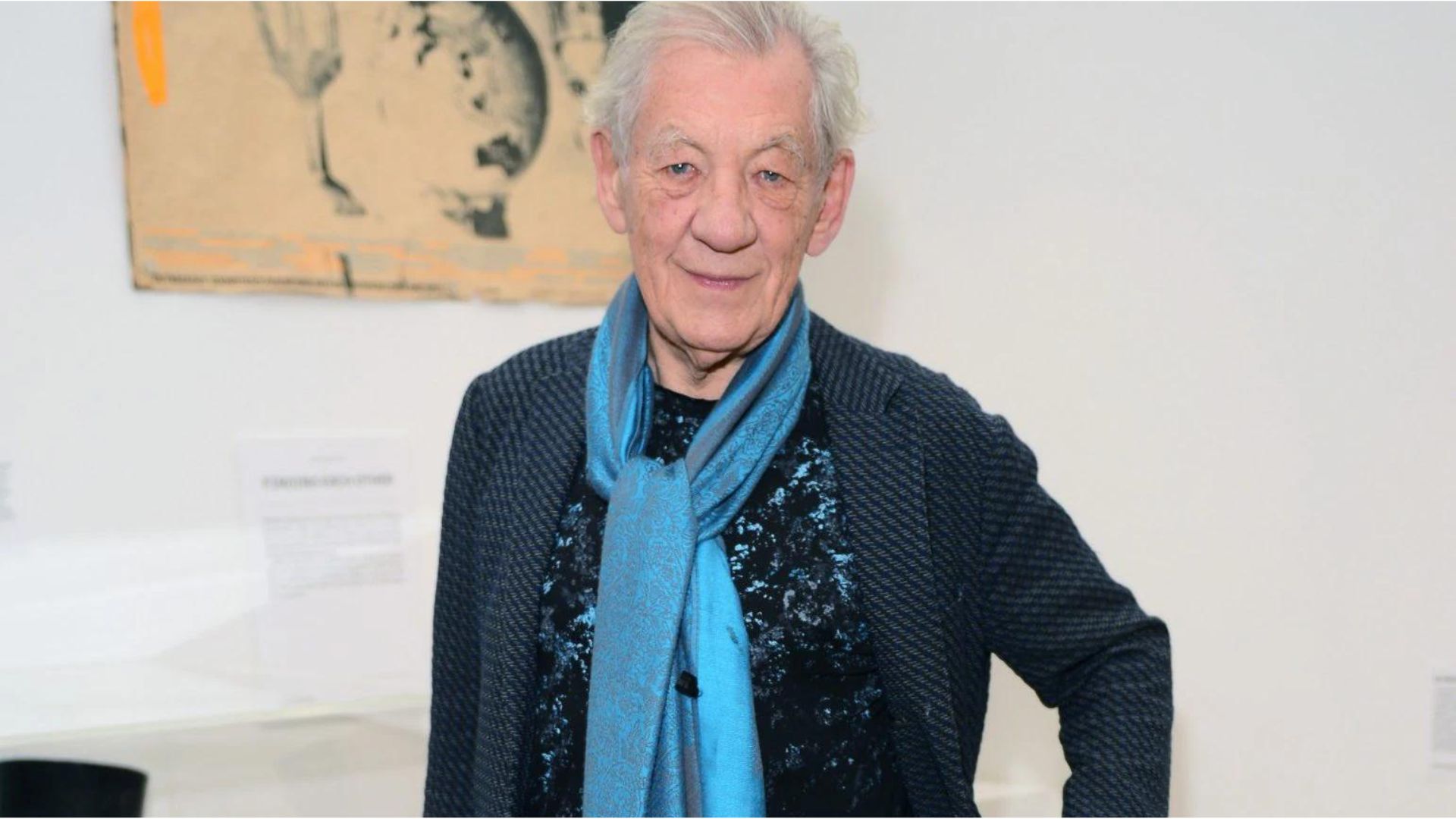 Sir Ian McKellen Standing And Wearing A Blue Scarf