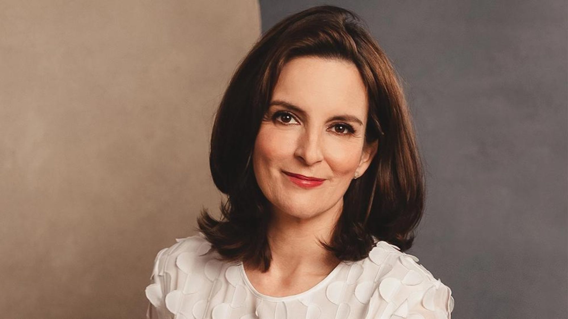 Tina Fey Smiling And Wearing White Clothes
