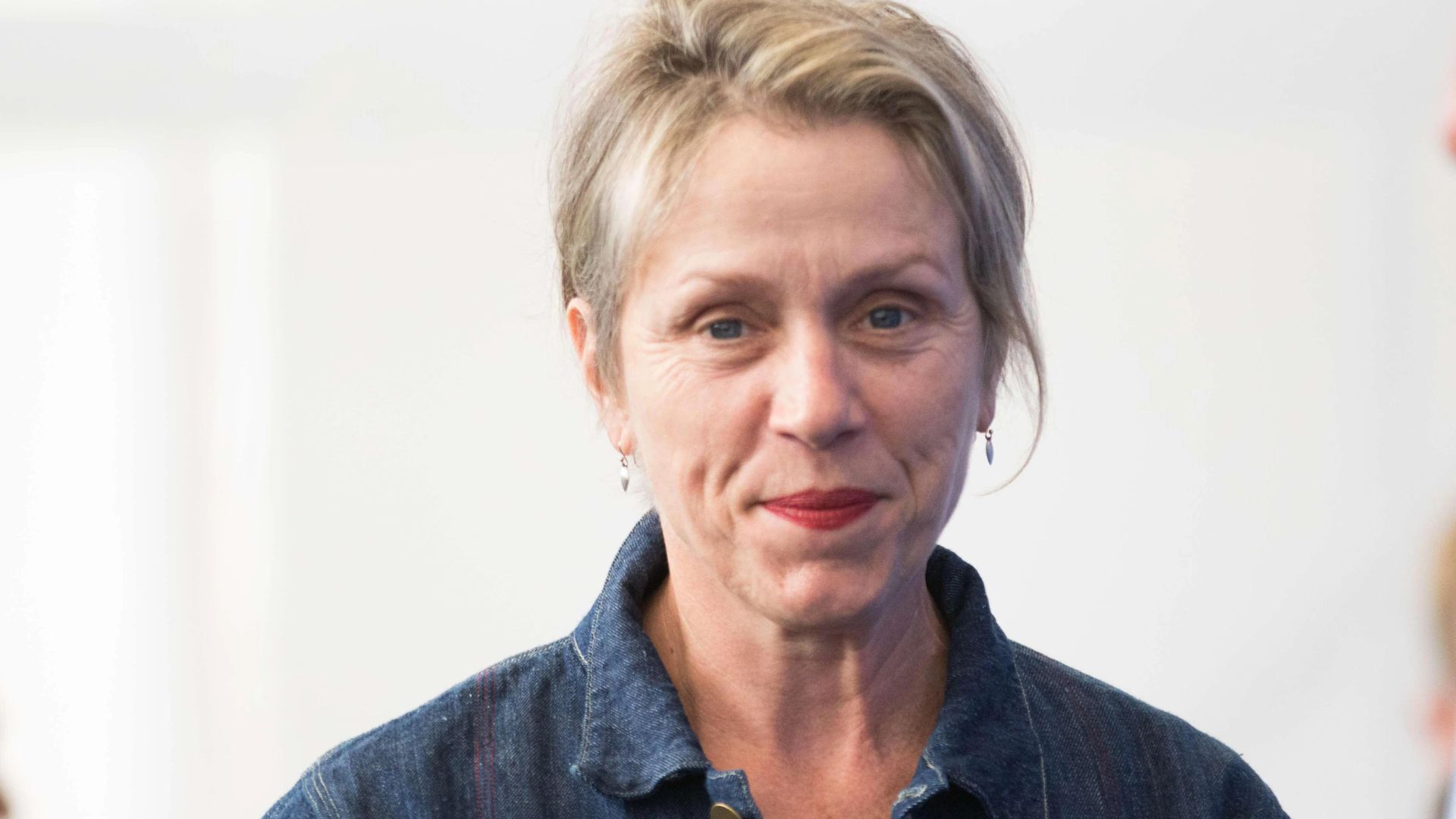 Frances McDormand Smiling And Wearing Blue Clothes