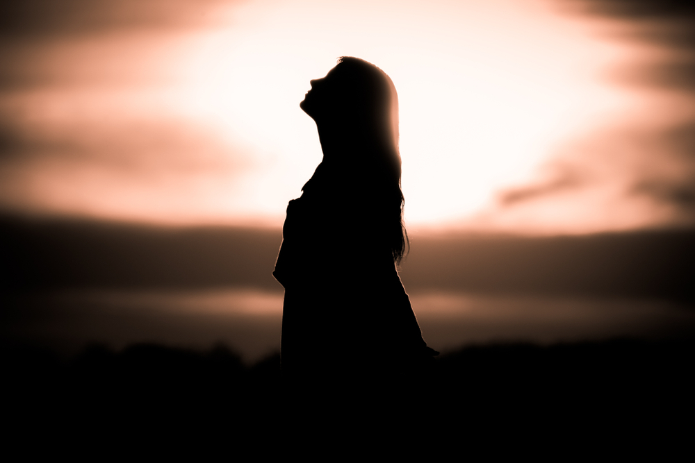 A woman's silhouette at sunset.