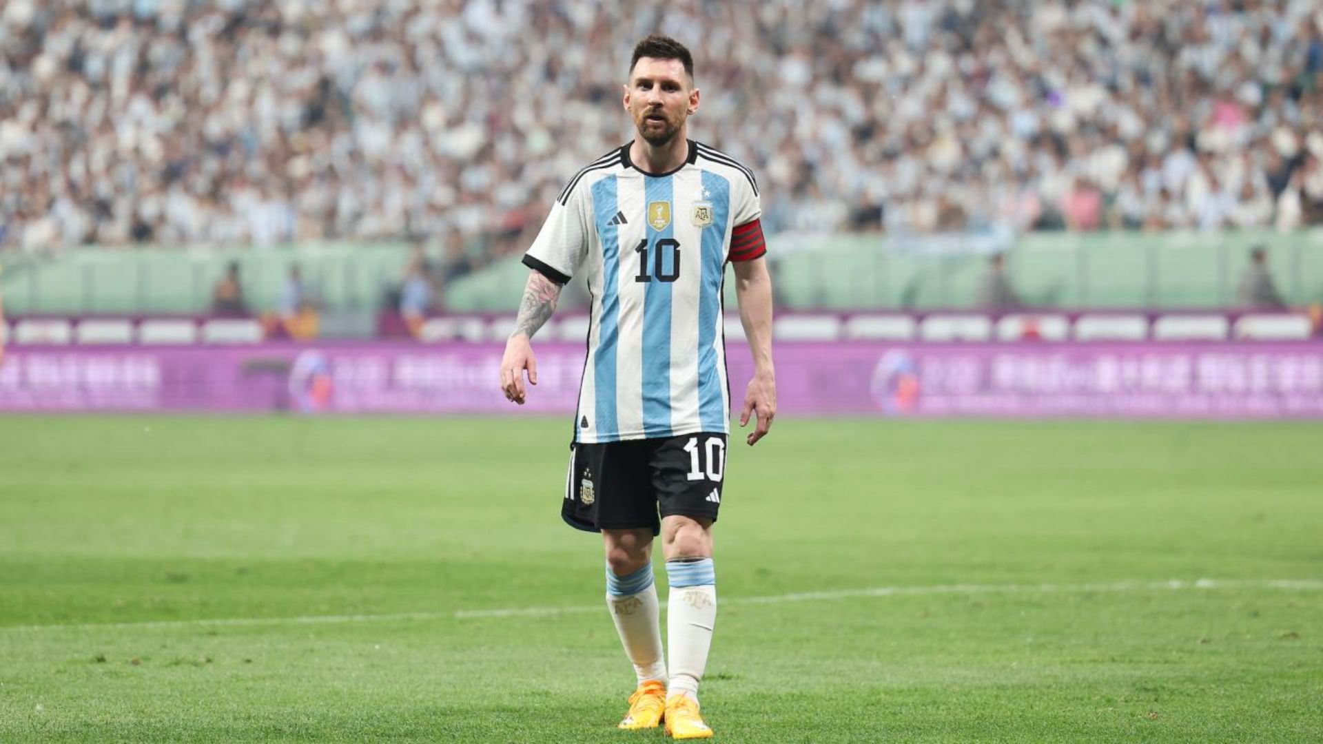 Lionel Messi Standing On A Football Field