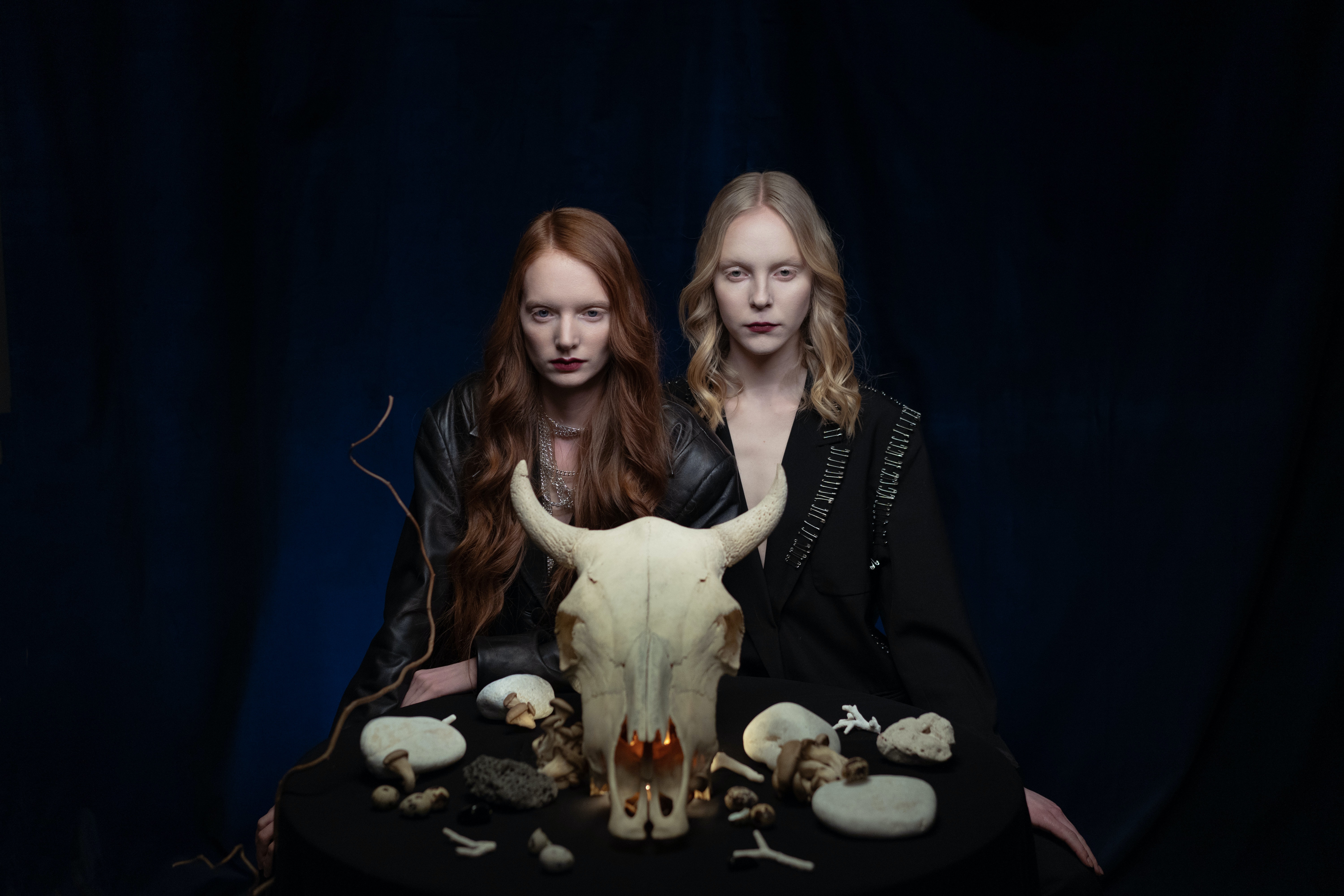 Two Women Near Stones and an Animal Head Skull