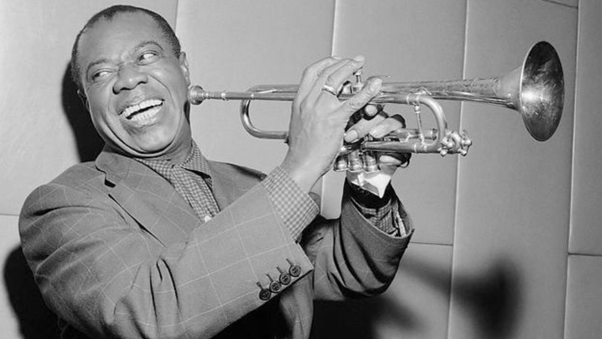 Louis Armstrong Laughing While Holding A Trumpet