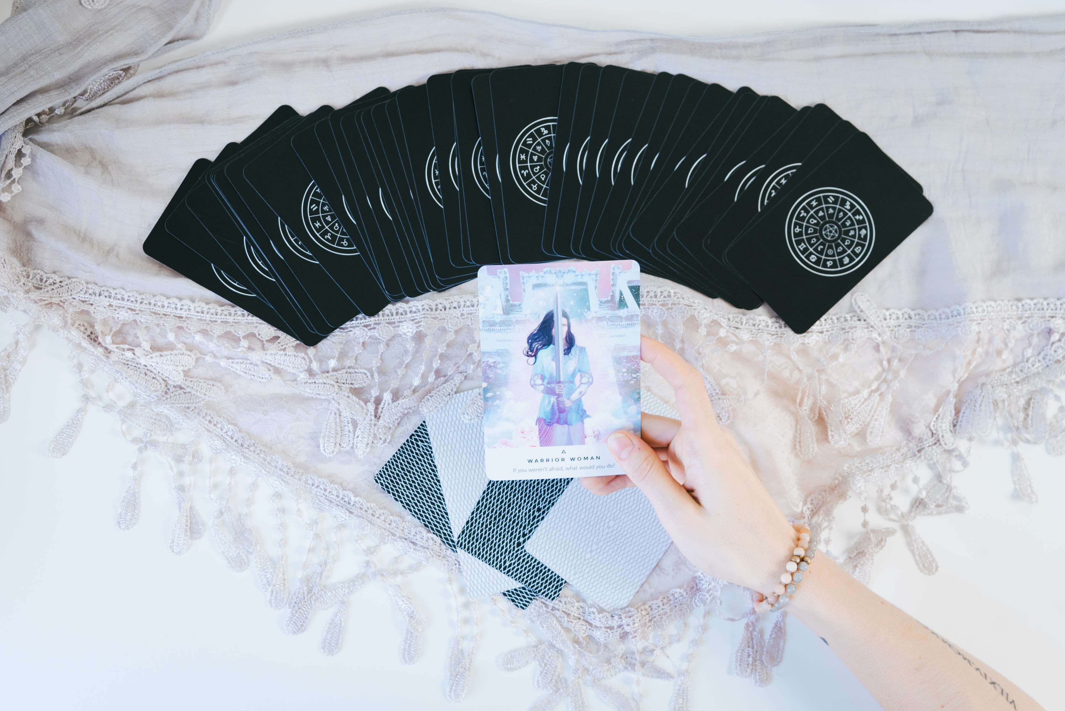 Woman Holding Colorful Cards With Black Cards In Front Of Her