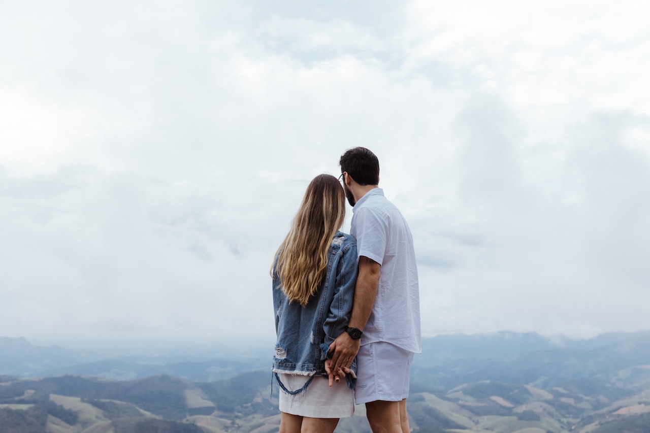 Couple Standing Together Facing the Mountains