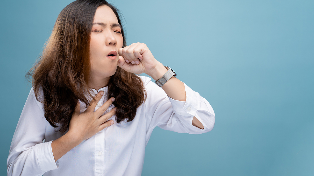 A Woman In White Shirt Coughing