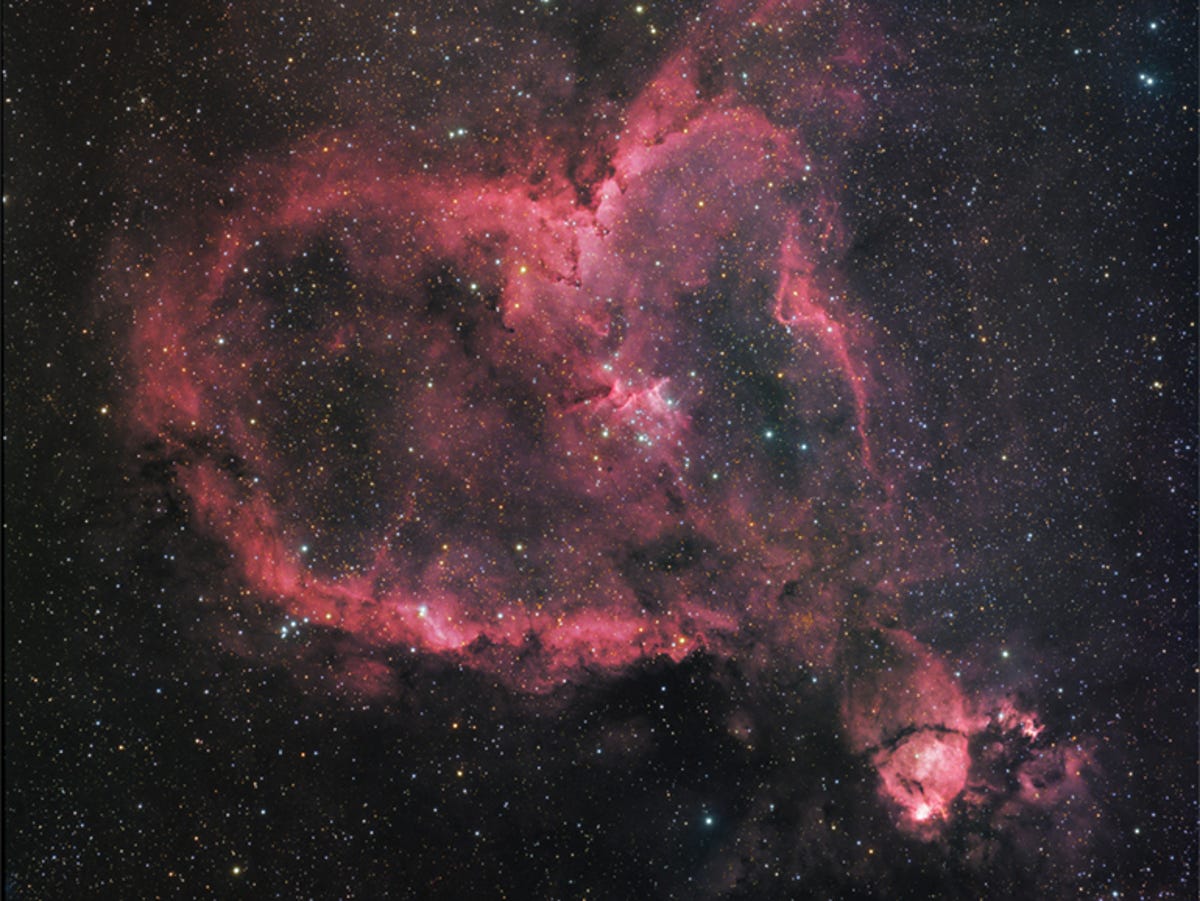 A pink galaxy forming a heart shape.