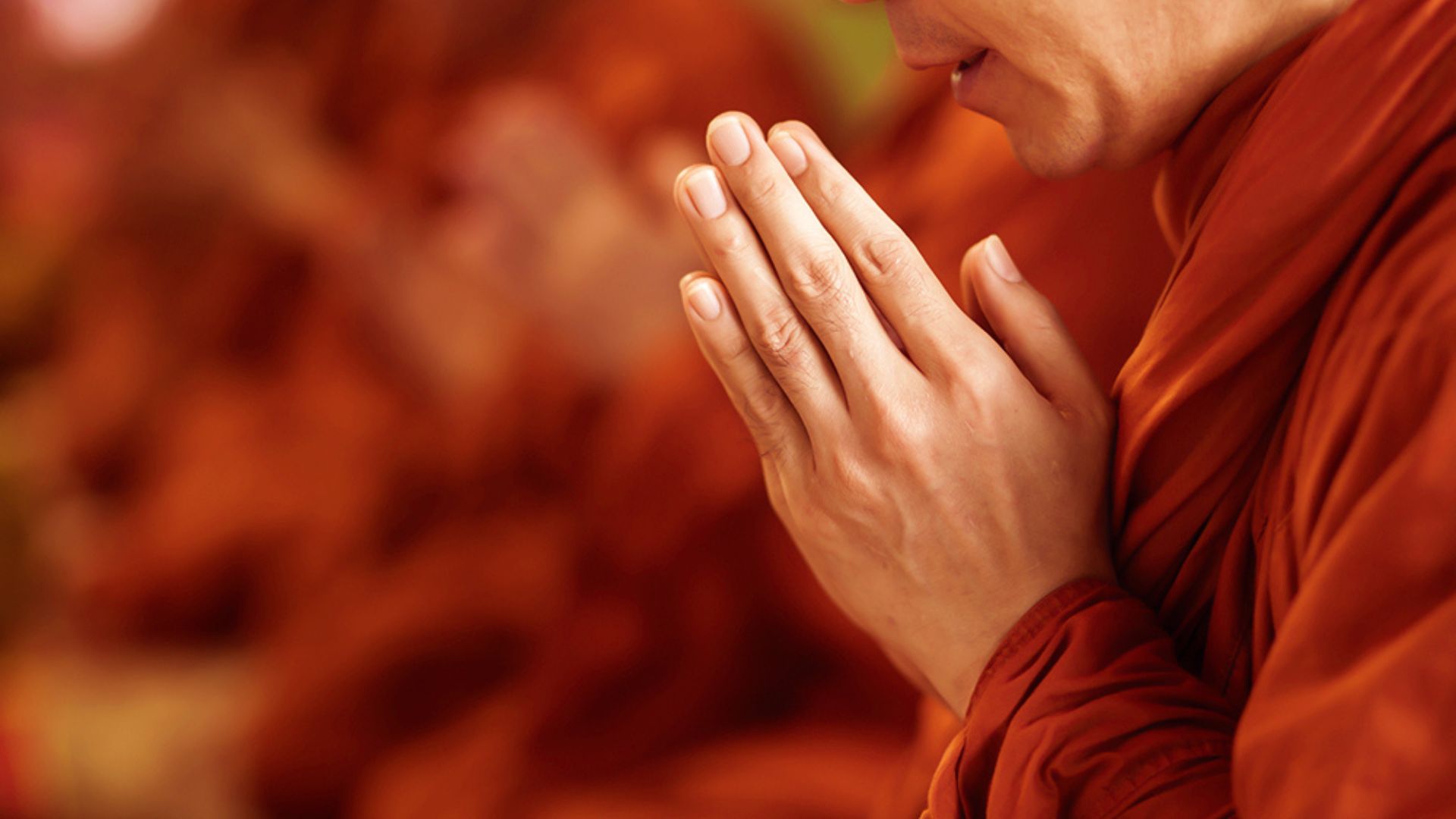 A Buddhist Praying With Both Hands Raised