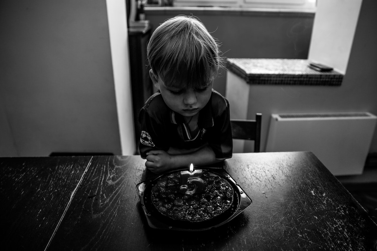 Boy Looking at Birthday Cake