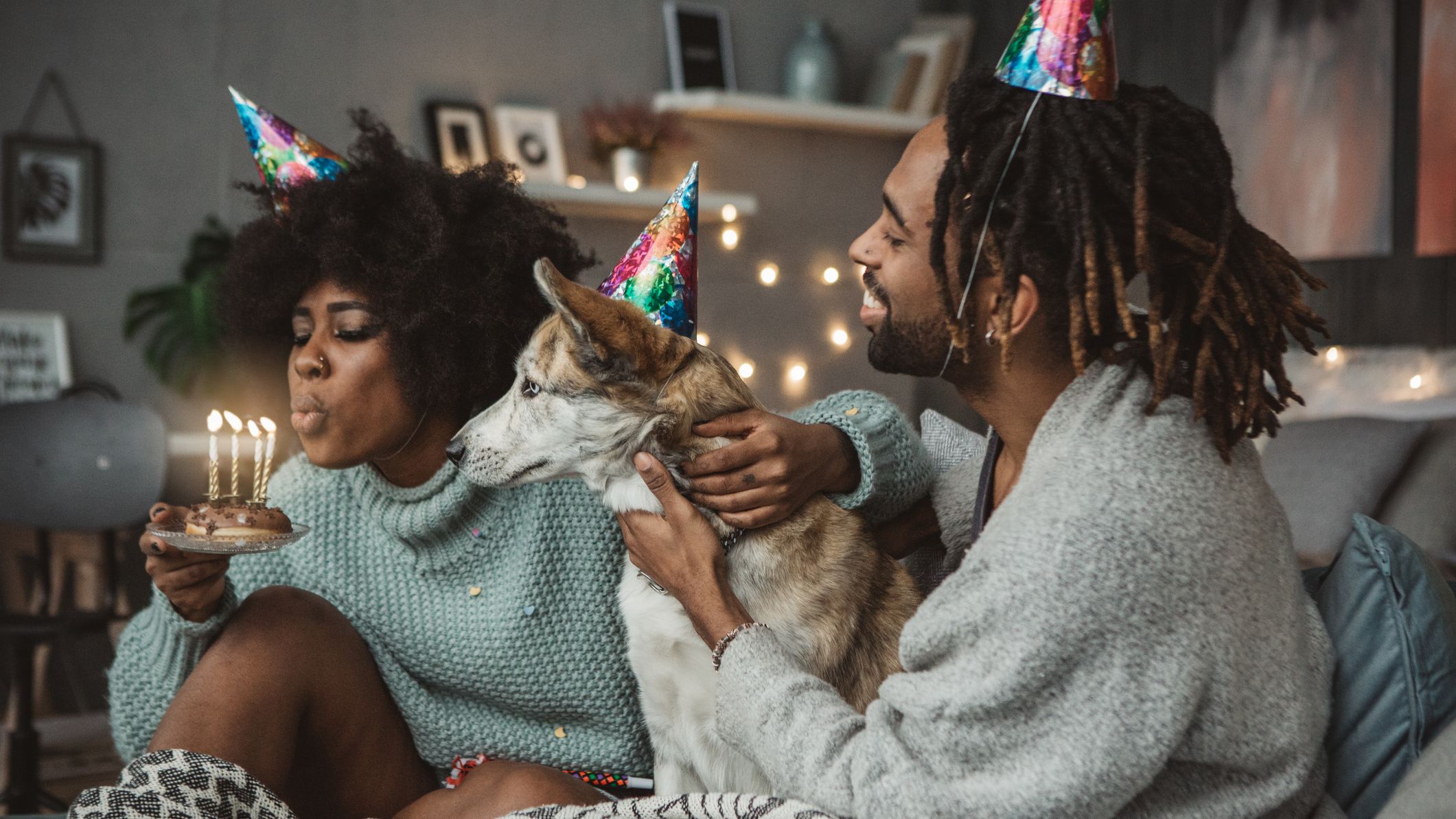 A Couple With A Dog Celebrating Woman's Borthday