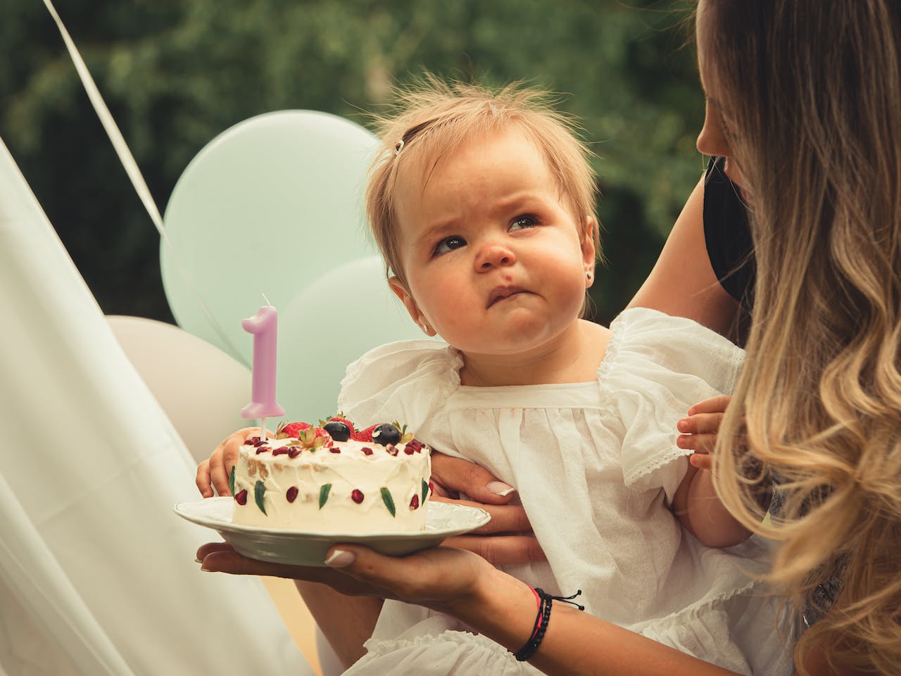 Child Frowning at a Plate with Cake
