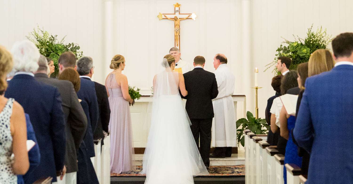 A Wedding In A Church In Front Of a Cross