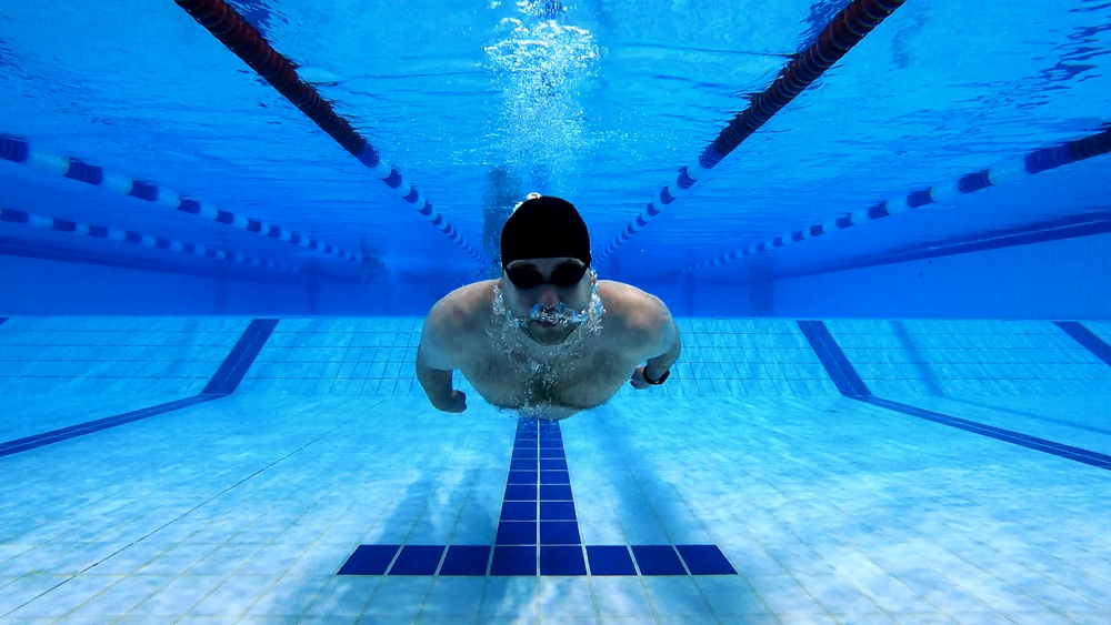 A professional male swimmer underwater