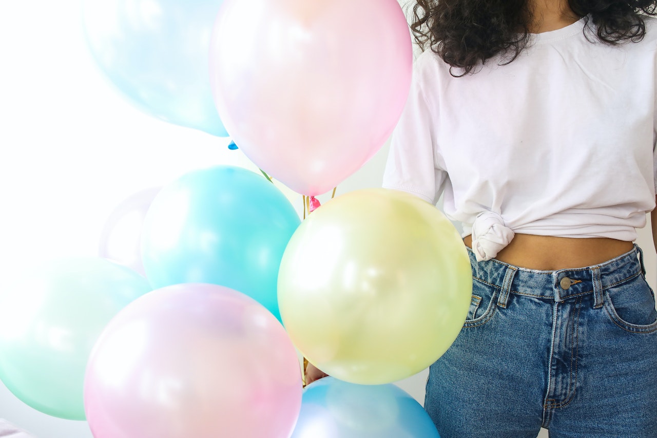 Pastel Balloons Held by a Woman