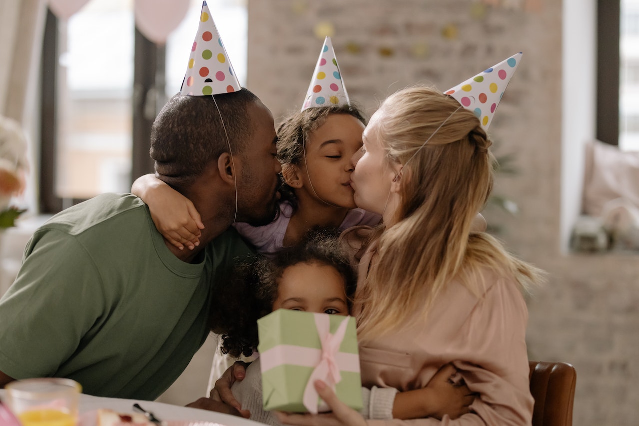 Girl Kissing Her Mother during Her Birthday