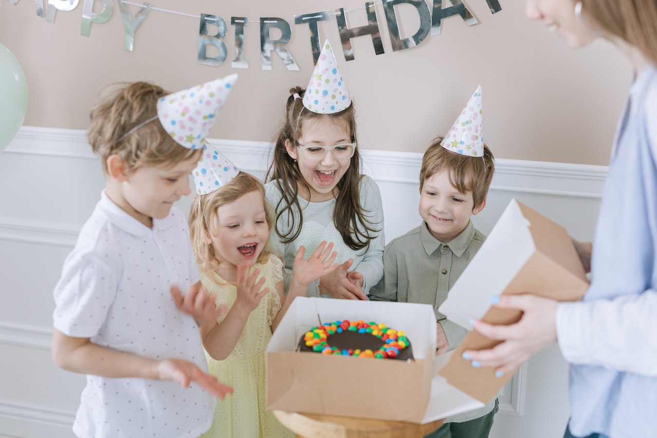 Kids Clapping Beside a Birthday Cake